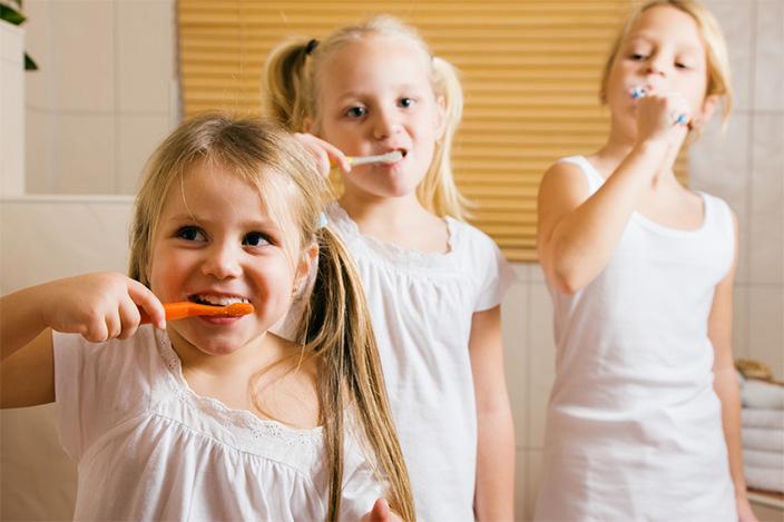 happy children brushing teeth