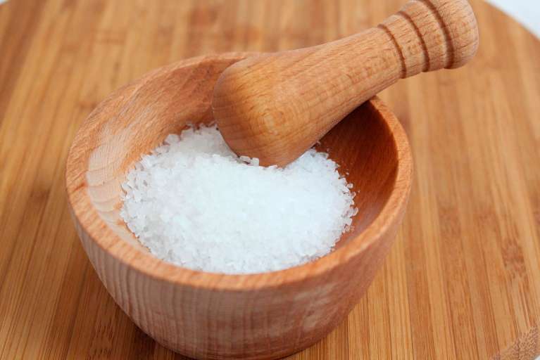 Sea salt in a wooden mortar and pestle