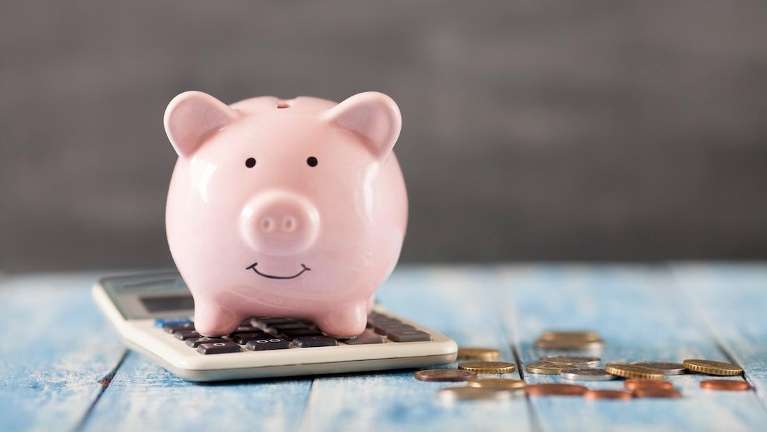 image of piggy bank on calculator, savings for dental membership plan