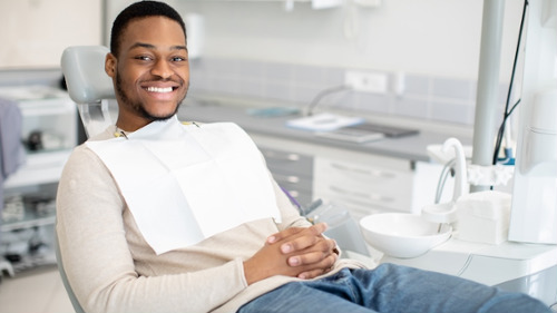 man in dental chair to check condition of teeth